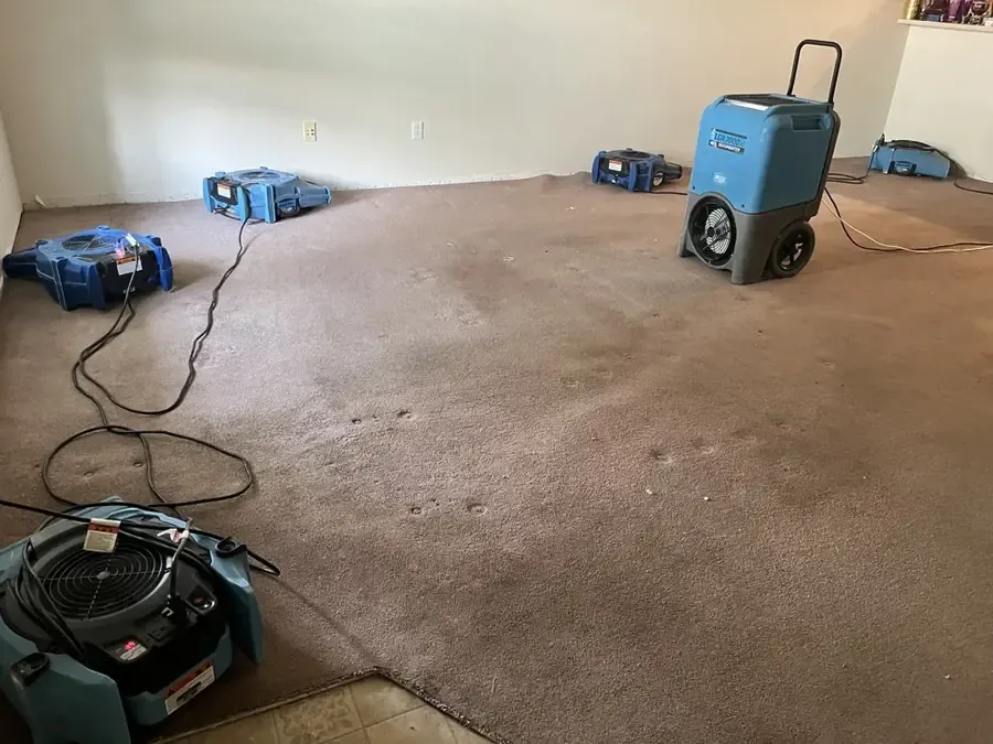 Cleanup under way in a home after a burst pipe