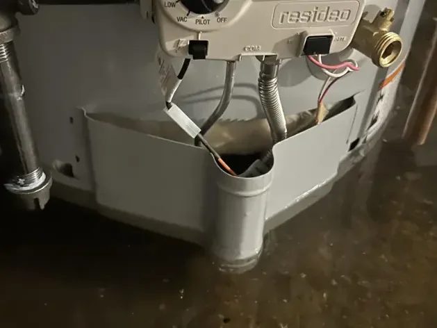 Gas water heater standing in a pool of leaked water